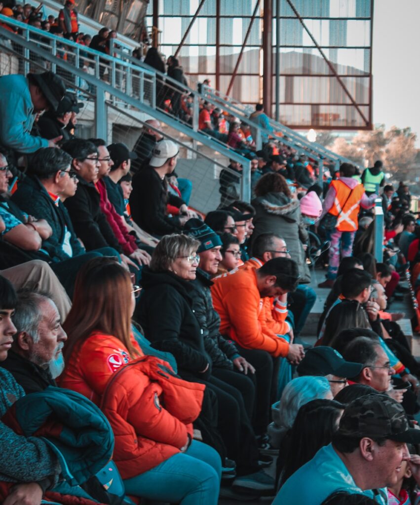 a large group of people sitting in a stadium