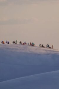 tourists enjoying sunset on lencois maranhenses dunes