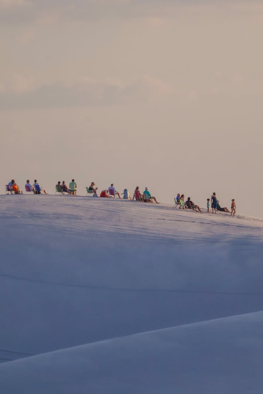 tourists enjoying sunset on lencois maranhenses dunes