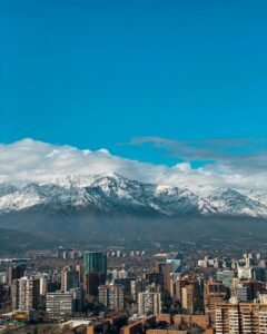 cityscape with blocks and snowcapped mountains