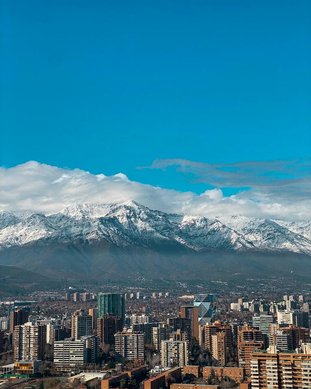 cityscape with blocks and snowcapped mountains