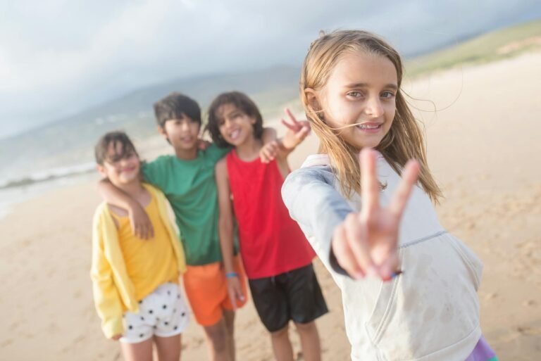 a girl doing peace sign with the kids at her back