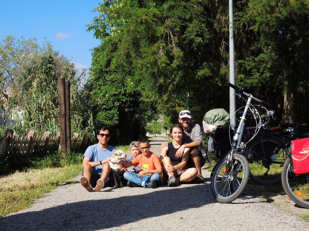 Família com crianças e cachorro descansando ao lado de bicicletas, aproveitando destinos de aventura Brasil acessíveis.