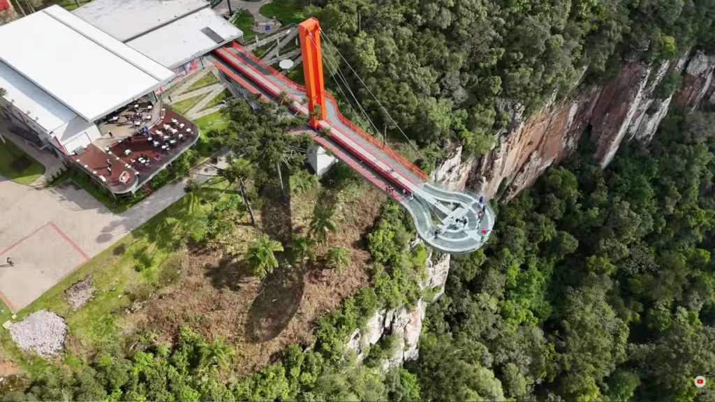 Vista aérea da atração Skyglass em Canela, uma plataforma de vidro suspensa sobre a natureza exuberante, atração moderna nas cidades pitorescas do Brasil.