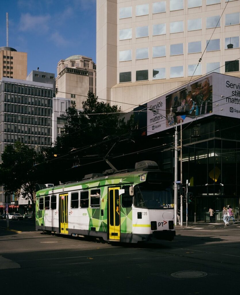 A tram travels through a city street.