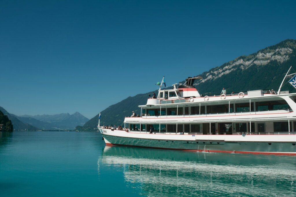 A large white boat floating on top of a lake