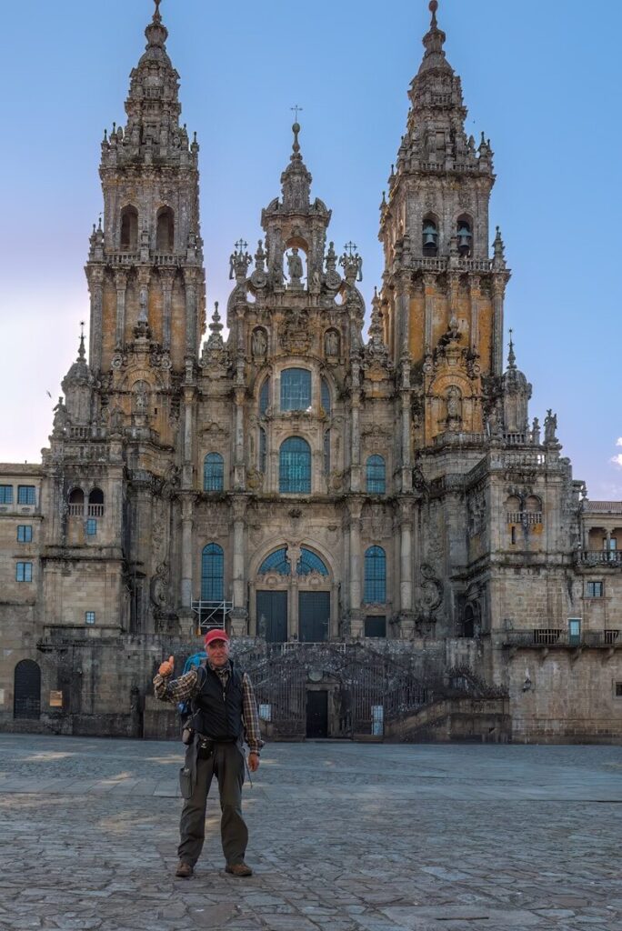 a man standing in front of a large building