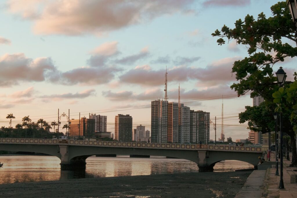 Beautiful sunset view over a bridge and city skyline in Recife, Brazil, capturing urban architecture and natural beauty.
