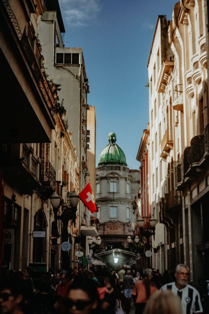 Vibrant street scene in Porto Alegre showcasing historic architecture and urban life under blue skies.