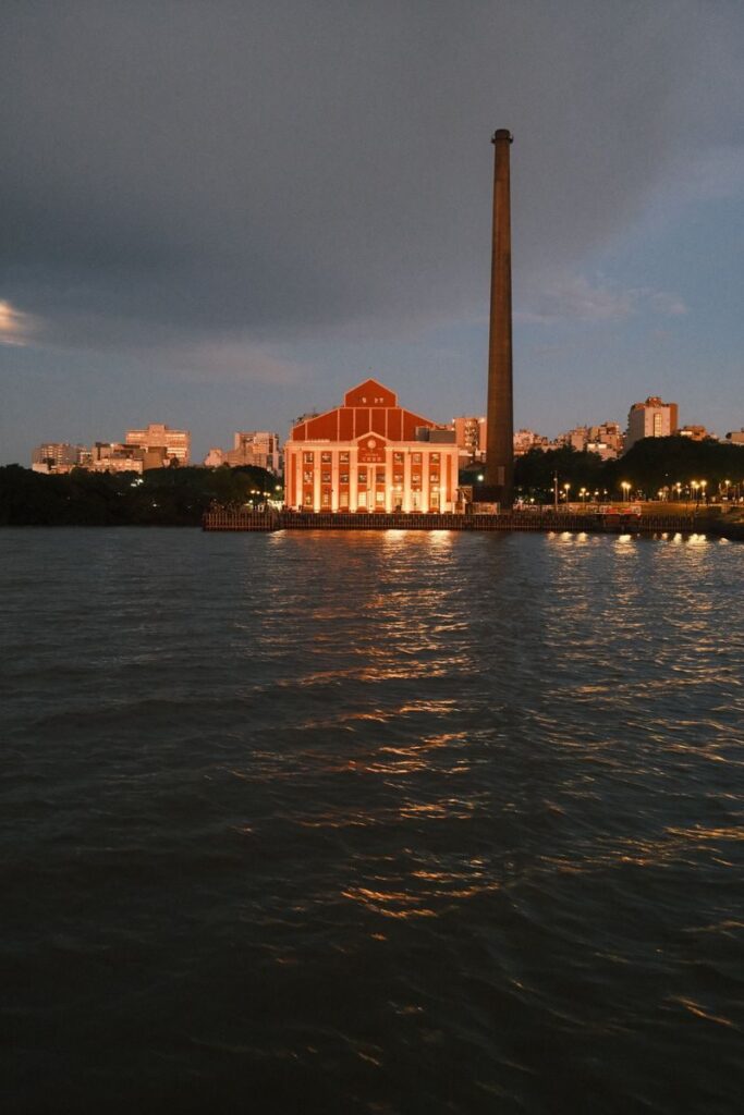 Scenic night view of Usina do Gasômetro reflecting in the waters of Porto Alegre, Brazil.