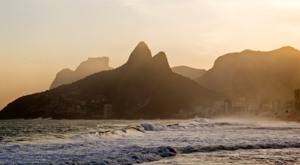 a view of a beach with mountains in the background