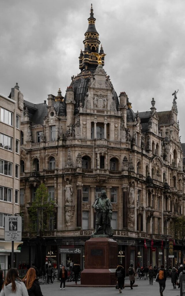 a large stone building with a statue in front of it